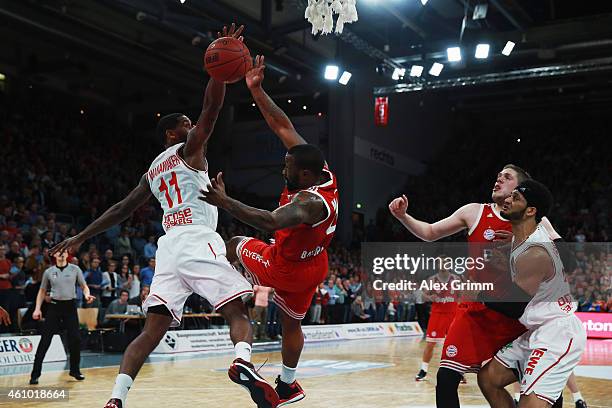 Bo McCalebb of Muenchen is challenged by Bradley Wanamaker of Brose Baskets during the Beko BBL basketball match between Brose Baskets and FC Bayern...