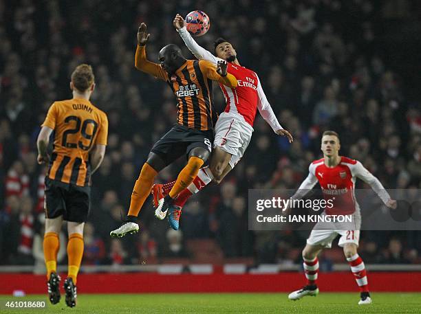 Hull City's Ivorian striker Yannick Sagbo vies with Arsenals French midfielder Francis Coquelin during the English FA Cup third round football match...