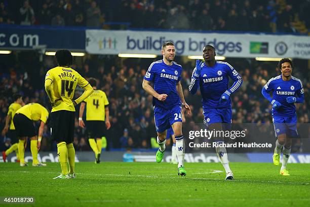 Watford players look dejected as Kurt Zouma of Chelsea celebrates with Gary Cahill and Loic Remy as he scores their third goal during the FA Cup...