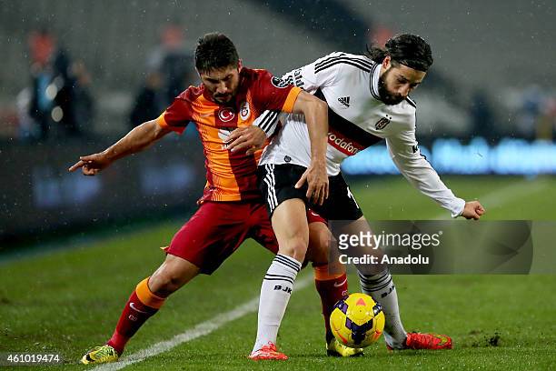 Olcay Sahan of Besiktas is in action against Sabri Sarioglu of Galatasaray during the Turkish Spor Toto Super League soccer match between Besiktas...