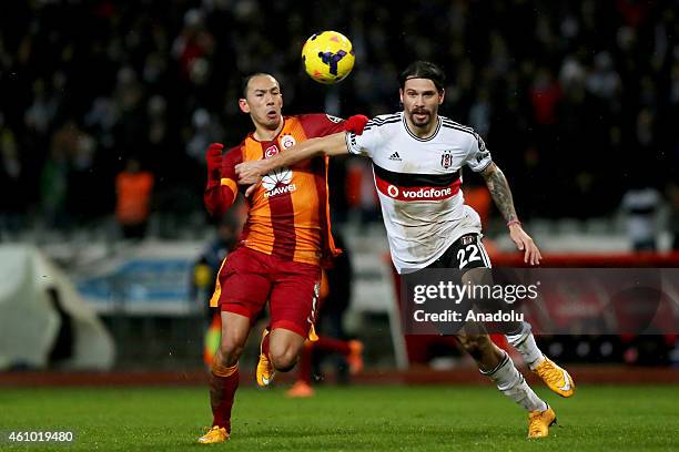 Ersan Gulum of Besiktas is in action against Umut Bulut of Galatasaray during the Turkish Spor Toto Super League soccer match between Besiktas and...