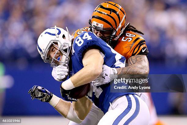 Jack Doyle of the Indianapolis Colts is tackled by Rey Maualuga of the Cincinnati Bengals in the first half during their AFC Wild Card game at Lucas...