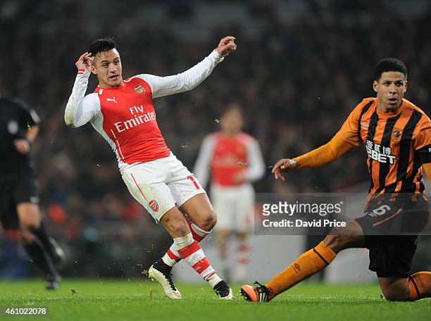 Alexis Sanchez scores Arsenal's 2nd goal as Curtis Davies of Hull looks on during the match between Arsenal and Hull City in the FA Cup 3rd Round at...