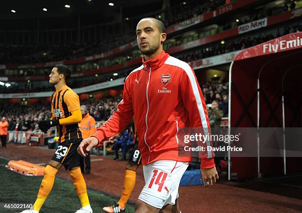 Theo Walcott of Arsenal walks out before the match between Arsenal and Hull City in the FA Cup 3rd Round at Emirates Stadium on January 4, 2015 in...