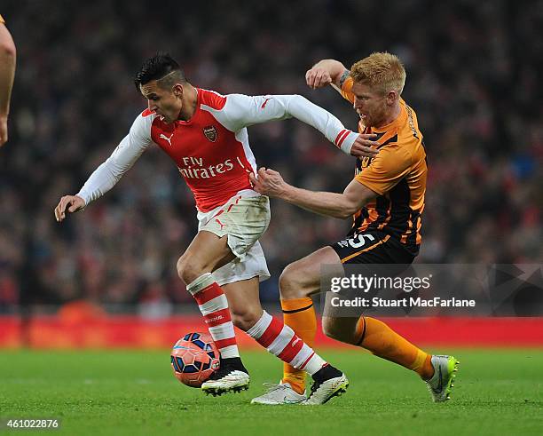 Alexis Sanchez of Arsenal holds off Paul McShane of Hull during the FA Cup Third Round match between Arsenal and Hull City at Emirates Stadium on...