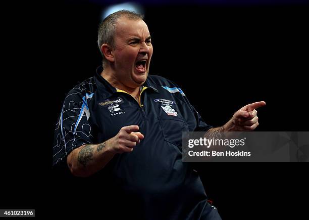 Phil Taylor of England celebrates winning a set during the final of the 2015 William Hill PDC World Darts Championships at Alexandra Palace on...