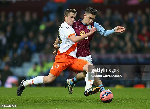 Mark Waddington of Blackpool is tackled by Jack Grealish of Aston Villa during the FA Cup Third Round Match between Aston Villa and Blackpool at...