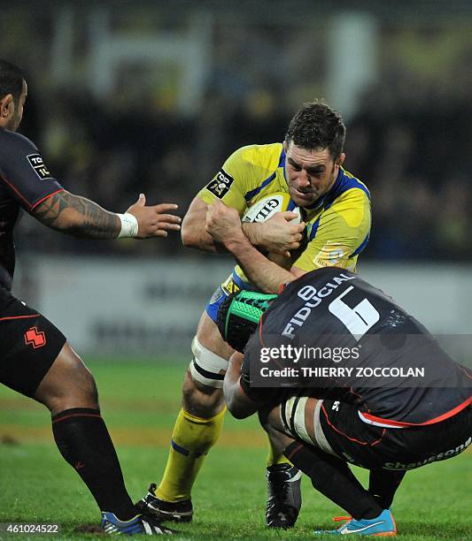 Clermont's Canadian lock Jamie Cudmore is tackled by Toulouse's players during the French Union Rugby match ASM Clermont vs ST Toulouse at the...