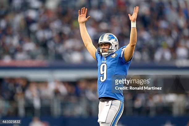 Quarterback Matthew Stafford of the Detroit Lions celebrates the 18-yard rushing touchdown by running back Reggie Bush in the first quarter against...