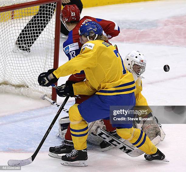 Linus Soderstrom stops Ilya Korenev as Julius Bergman backchecks as Team Russia plays Team Sweden in the semi final round of the IIHF World Junior...