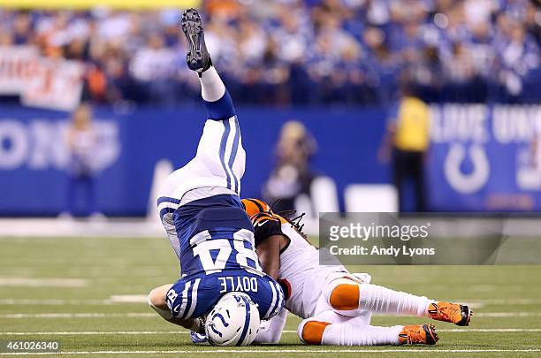 Jack Doyle of the Indianapolis Colts is tackled by Rey Maualaga of the Cincinnati Bengals during their AFC Wild Card game at Lucas Oil Stadium on...
