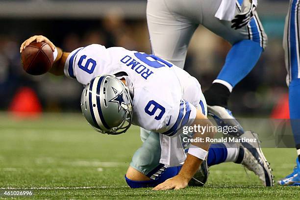 Quarterback Tony Romo of the Dallas Cowboys reacts after taking a sack in the third quarter against the Detroit Lions during the NFC Wildcard Playoff...