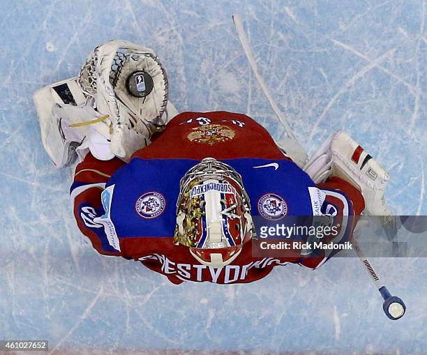 After making a stop, Russian goalie Igor Shestyorkin holds the puck in his glove hand waiting for the official to come collect it. 2015 IIHF World...