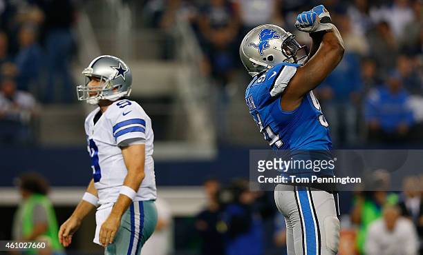 Ezekiel Ansah of the Detroit Lions celebrates as Tony Romo of the Dallas Cowboys walks past during the second half of their NFC Wild Card Playoff...