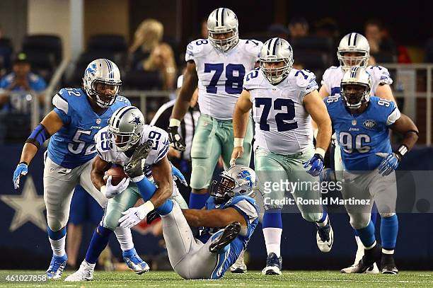 DeMarco Murray of the Dallas Cowboys tries to break away from DeAndre Levy of the Detroit Lions during the second half of their NFC Wild Card Playoff...