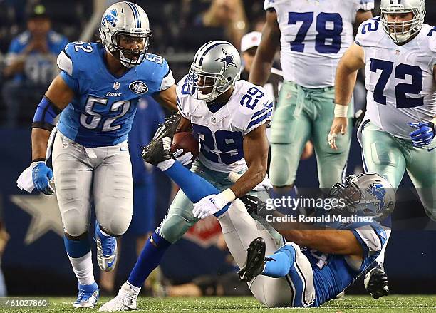 DeMarco Murray of the Dallas Cowboys tries to break away from DeAndre Levy of the Detroit Lions during the second half of their NFC Wild Card Playoff...