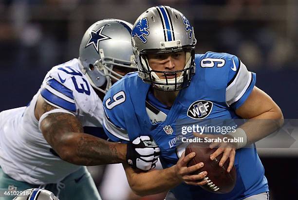 Matthew Stafford of the Detroit Lions is pressured by Anthony Spencer of the Dallas Cowboys during the second half of their NFC Wild Card Playoff...