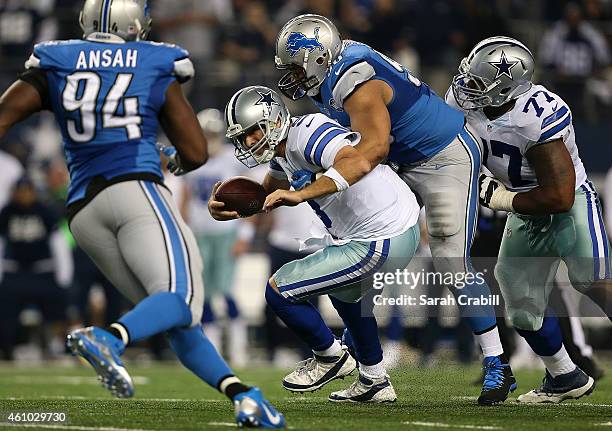 Ndamukong Suh of the Detroit Lions tackles Tony Romo of the Dallas Cowboys during a NFC Wild Card Playoff game at AT&T Stadium on January 4, 2015 in...