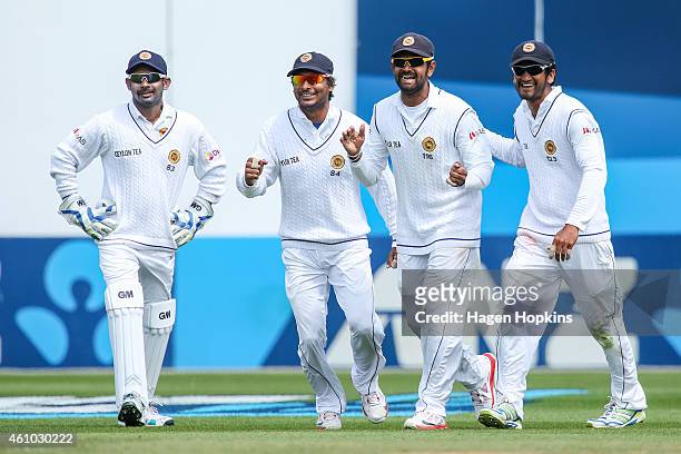 To R, Prasanna Jayawardene, Kumar Sangakkara, Lahiru Thirimanne and Dimuth Karunaratne of Sri Lanka celebrate the wicket of James Neesham of New...