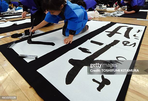 Boy writes a letter during the 51st annual new year Calligraphy contest at the Budokan hall in Tokyo on January 5, 2015. About 3,150 people...