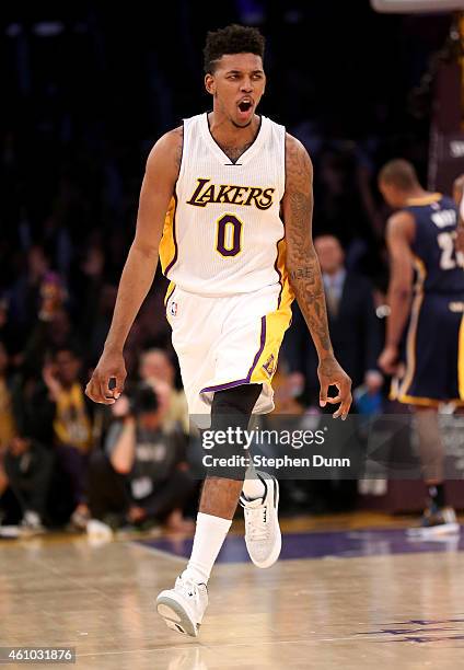 Nick Young of the Los Angeles Lakers celebrates after stealing the ball and making a three point shot at the buzzer ending the second quarter against...