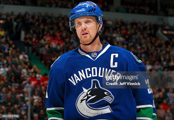 Henrik Sedin of the Vancouver Canucks looks on from the bench during their NHL game against the Detroit Red Wings at Rogers Arena January 3, 2015 in...