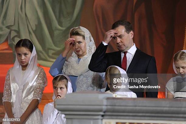 Russian Prime Minister Dmitry Medvedev and his wife Svetlana Medvedeva pray during the Christmas Mass in the Christ the Saviour Cathedral in the...