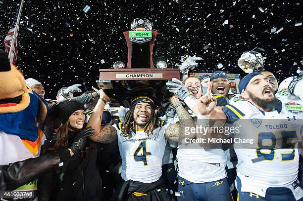 Defensive back Jordan Haden of the Toledo Rockets holds up the GoDaddy trophy while celebrating with other teammates on January 4, 2015 at...