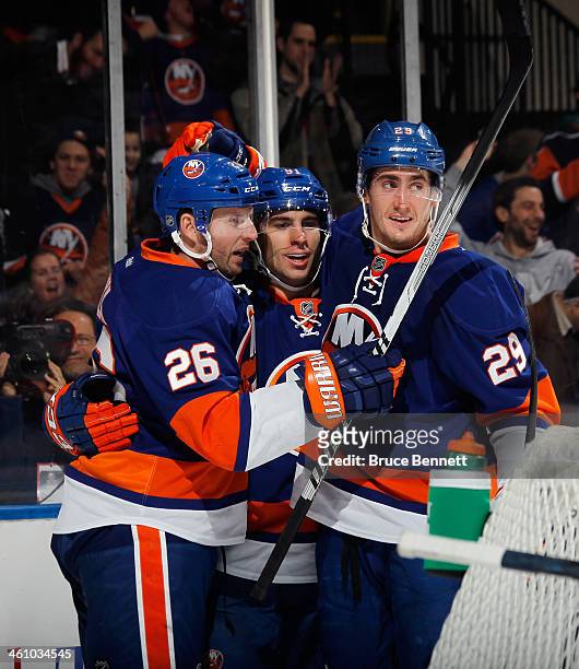 Thomas Vanek, John Tavares and Brock Nelson of the New York Islanders celebrate a second period goal by Tavares against the Dallas Stars at the...