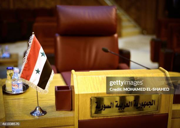 The empty seat of Syria is seen during an emergency representatives meeting to discuss the conflict in Libya, at the Arab League headquarters in...