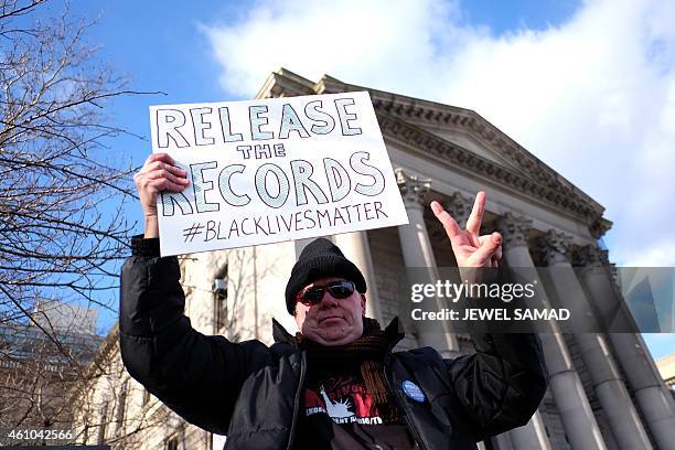 Protester displays a placard during a demonstration outside the courthouse in New York's borough of Staten Island on January 5 before a hearing in a...