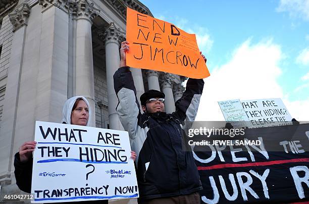 Protesters display a banner and placards during a demonstration outside the courthouse in New York's borough of Staten Island on January 5 before a...