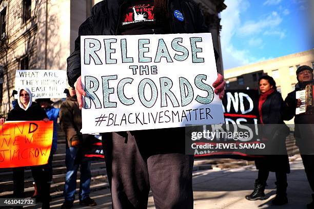 Protesters display a banner and placards during a demonstration outside the courthouse in New York's borough of Staten Island on January 5 before a...