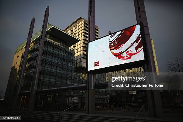 Giant outdoor television screen broadcasts the BBC News at Media City in Salford Quays which is home to the BBC, ITV television studios and also...