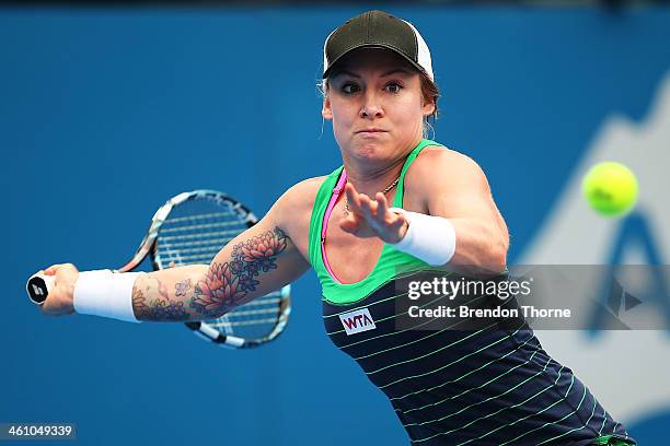 Bethanie Mattek-Sands of the USA plays a forehand in her second round match against Agnieszka Radwanska of Poland during day three of the 2014 Sydney...