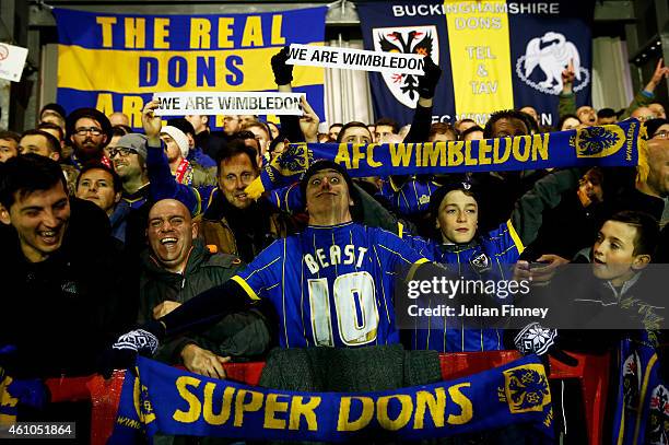 Wimbledon fans cheer on their team during the FA Cup Third Round match between AFC Wimbledon and Liverpool at The Cherry Red Records Stadium on...