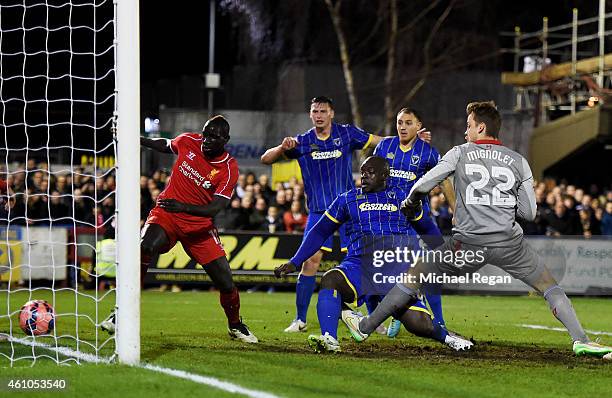 Adebayo Akinfenwa of AFC Wimbledon pokes the ball into the net to score a goal and level the scores at 1-1 during the FA Cup Third Round match...