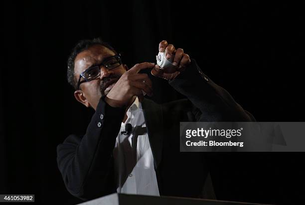 Raj Talluri, senior vice president of Qualcomm Inc., displays the chip for a smart lightbulb during the 2015 Consumer Electronics Show in Las Vegas,...