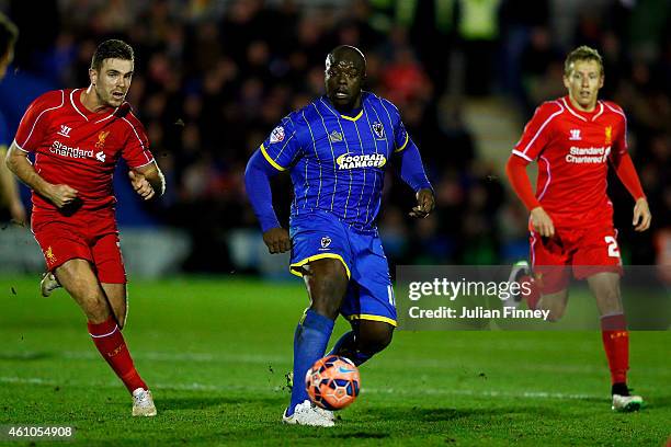 Adebayo Akinfenwa of AFC Wimbledon runs with the ball during the FA Cup Third Round match between AFC Wimbledon and Liverpool at The Cherry Red...