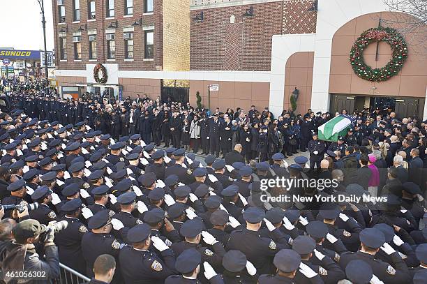 The casket of New York Police Department officer Rafael Ramos is brought out of Christ Tabernacle Church during his funeral on Saturday, Dec. 27,...