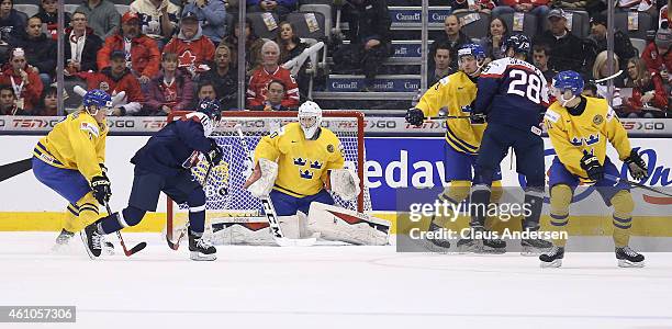 Martin Reway of Team Slovakia tips a shot at Linus Soderstrom of Team Sweden during the bronze medal game in the 2015 IIHF World Junior Hockey...