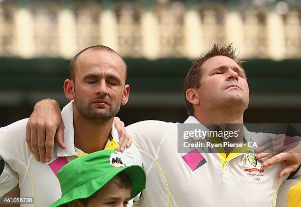 Nathan Lyon and Ryan Harris of Australia react during the national anthem during day one of the Fourth Test match between Australia and India at...