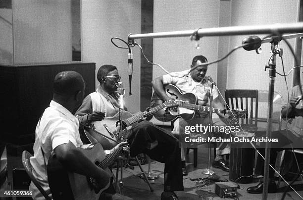 Bluesmen Brownie McGhee, Lightnin' Hopkins, Big Joe Williams and Sonny Terry in the studio recording Hopkins' album 'Penitentiary Blues' on July 1960...