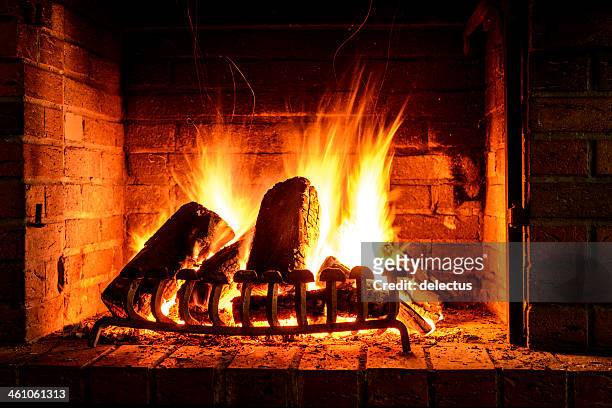 fire in a fireplace - warming up stock pictures, royalty-free photos & images