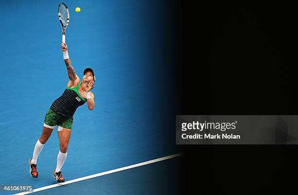Bethanie Mattek-Sands of the USA serves in her second round match against Agnieszka Radwanska of Poland during day three of the 2014 Sydney...