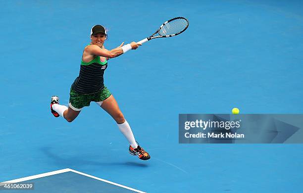 Bethanie Mattek-Sands of the USA plays a forehand in her second round match against Agnieszka Radwanska of Poland during day three of the 2014 Sydney...