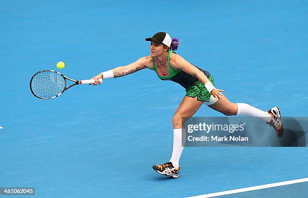 Bethanie Mattek-Sands of the USA plays a forehand in her second round match against Agnieszka Radwanska of Poland during day three of the 2014 Sydney...