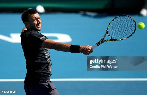 Michal Przysiezny of Poland plays a backhand during his first round match against Benoit Paire of France on day two of the Heineken Open at the ASB...