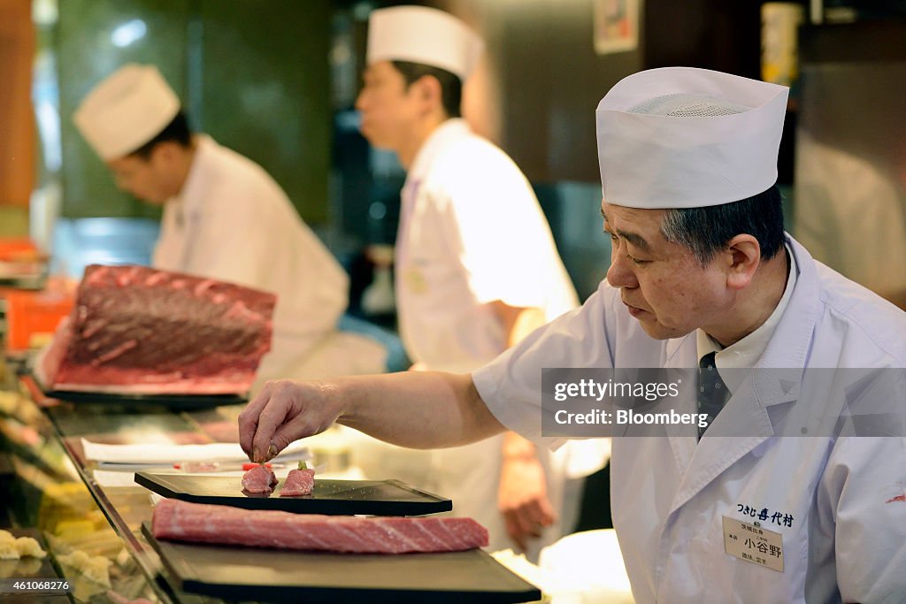 Sushi Preparation And Diners Inside A Sushi Zanmai Restaurant