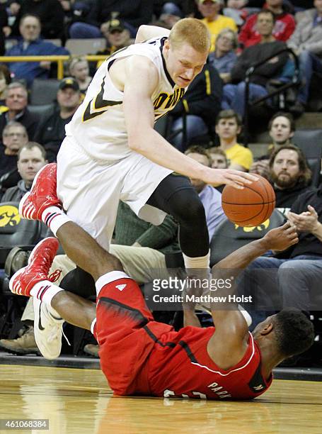 Forward Aaron White of the Iowa Hawkeyes chases a loose ball against guard Benny Parker of the Nebraska Cornhuskers, in the first half on January 5,...